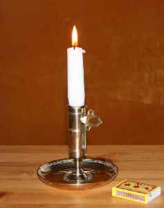 Candle: Solid block of wax with embedded wick