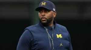 Fired University of Michigan football coach charged with stalking