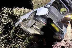 Dramatic moment car ends up buried in hedge 'after hitting pothole'