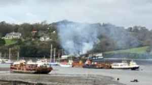 Firefighters tackling boat blaze in estuary