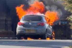 Car engulfed in flames outside village church as fire crews race to scene