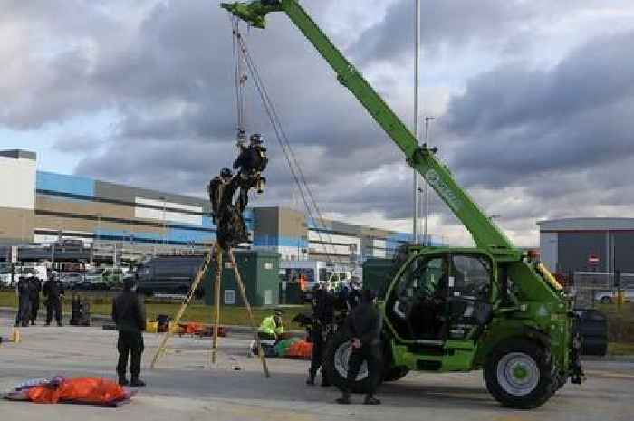 Amazon Dartford Extinction Rebellion protest: Police officer hangs from forklift to remove activist