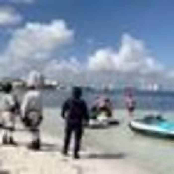 Tourists run for cover after gunmen on  jet skis  open fire on the beachfront of Cancun