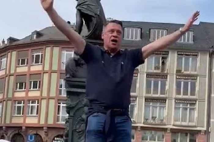 West Ham legend Tony Cottee climbs on fountain and leads Europa League chants in Germany