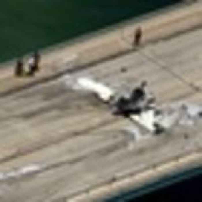 Small plane crashes on bridge near Miami, striking an SUV