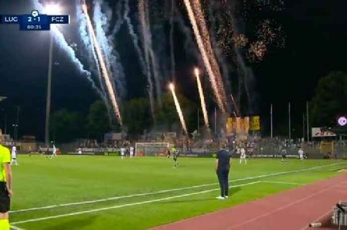 Swiss football fans begin firework show inside stadium while their team is losing