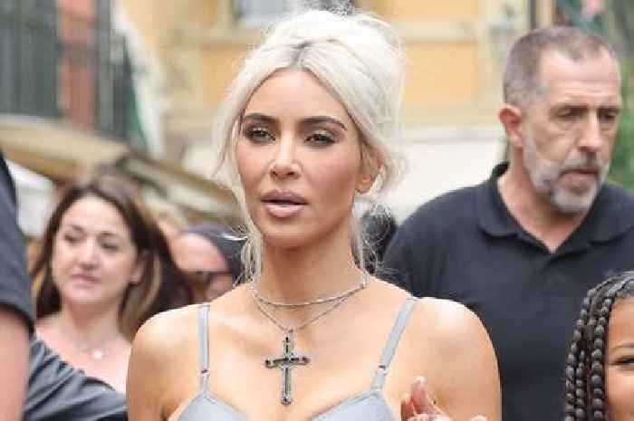 Kim Kardashian stuns on the streets of Italy in skin tight catsuit hours before Kourtney's wedding