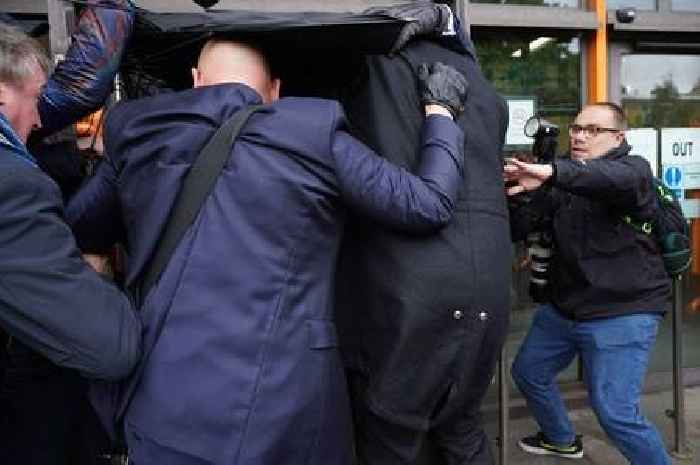 Kurt Zouma hides under brolly outside court as he arrives for cat-kick hearing