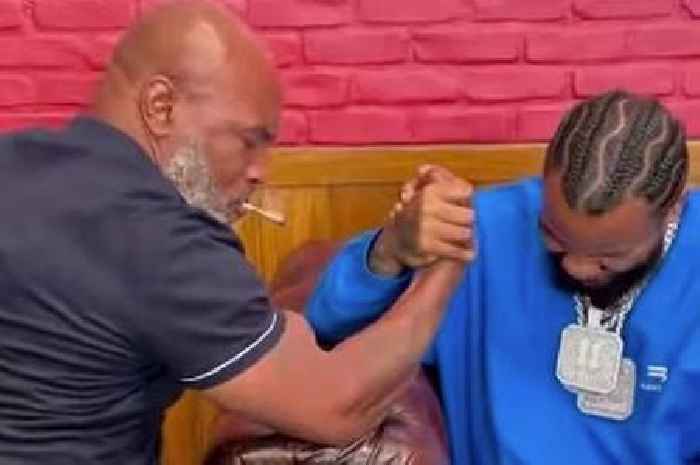 Mike Tyson wins arm wrestle while smoking spliff as opponent tells him to 