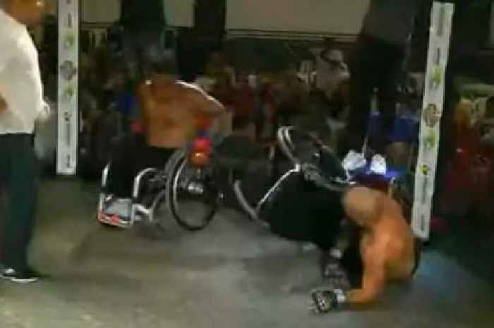 MMA fighters scrap in wheelchairs and exchange heavy blows until one falls out of seat