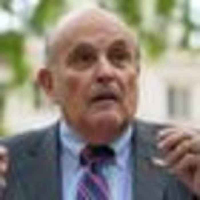 Shop worker held by police after Rudy Giuliani 'slapped on the back'