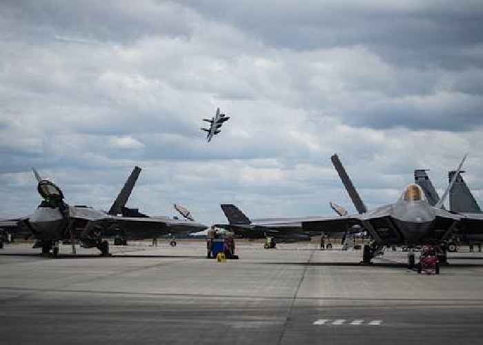 F-15 Eagle Buzzes Parked Raptors, Because What Can Be Cooler