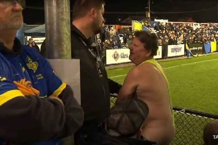 Mankini-wearing streaker escorted from football match after trying to invade the pitch