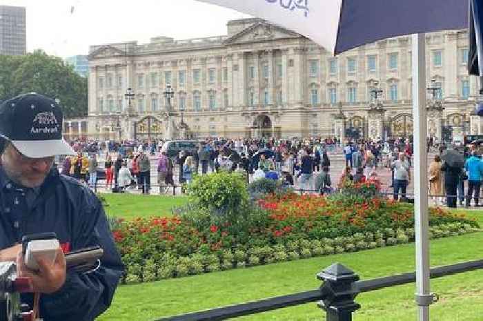 Buckingham Palace crowds swell to hundreds as people begin laying flowers for the Queen