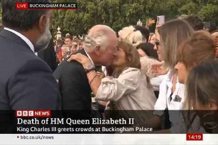 A kiss for a King: Charles goes on Buckingham Palace walkabout amid emotional scenes