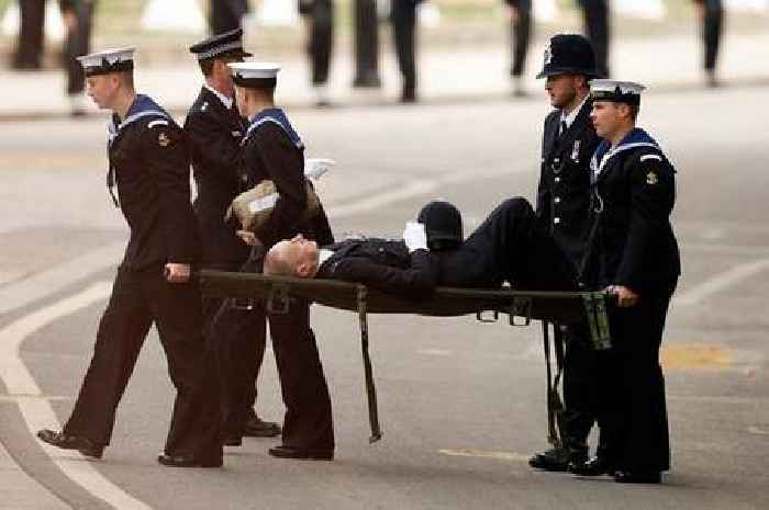 Police officer collapses during Queen's funeral and is carried away on stretcher