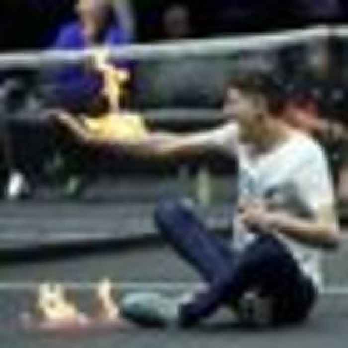 Protester sets arm on fire on court ahead of Federer's farewell tennis match