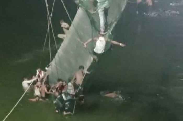Sixty killed as pedestrian bridge collapse in India plunges hundreds into river