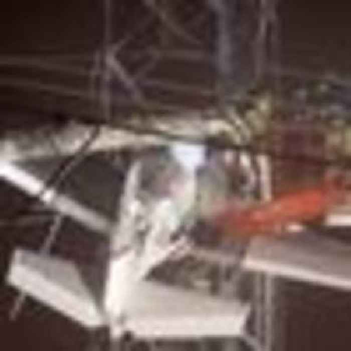 Pilot and passenger trapped for seven hours rescued after plane crashes into live power lines 100ft above ground