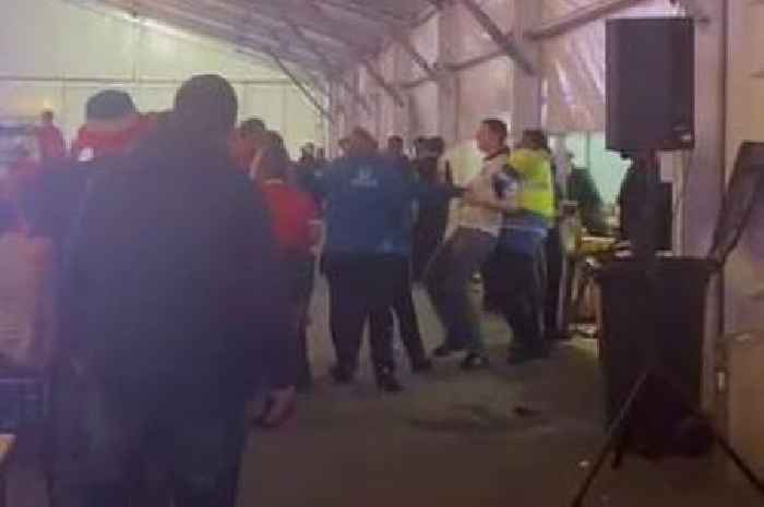 Security staff lead football fans away in disturbance at Swansea World Cup fan zone