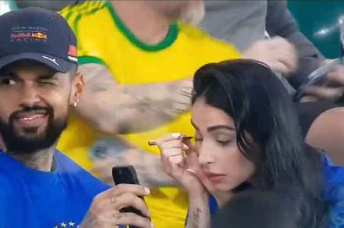 Brazil fan 'busted' by stunning partner as she catches him giving cheeky wink