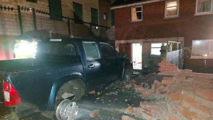 Driver smashes stolen car into garden of west Belfast home