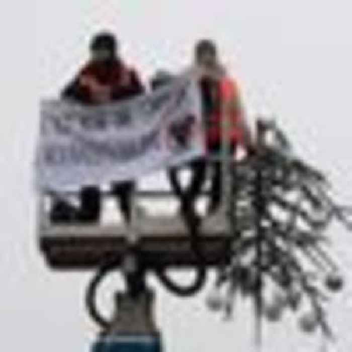 Activists cut off top of huge Christmas tree in climate protest