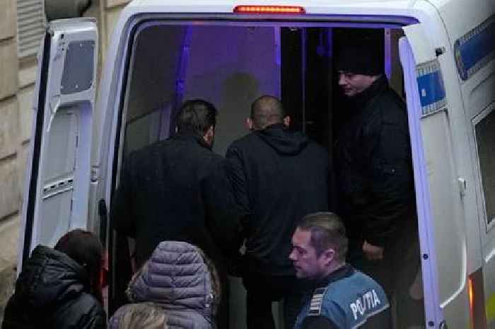 Andrew Tate cuffed and bundled into police van as he awaits ruling from Romania jail