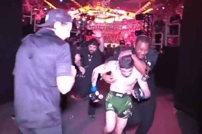 UFC champion forced to leg it out of arena as angry fans hurl bottles at fighter