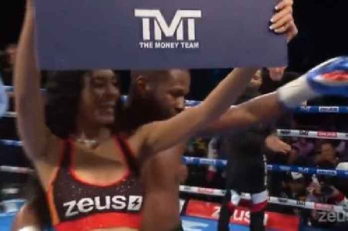 Floyd Mayweather dances with a ring girl in between rounds during Aaron Chalmers fight