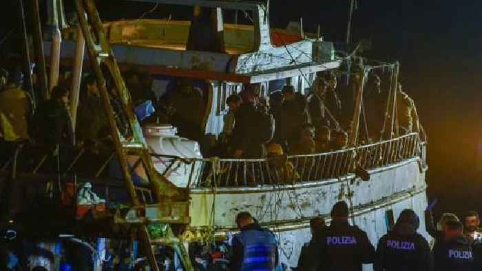 Italy's coast guard, navy, bring hundreds of migrants ashore