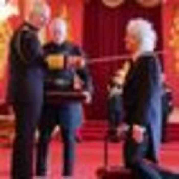 Arise, Sir Brian May! Queen star's knees 'just about' hold out as he is knighted by the King