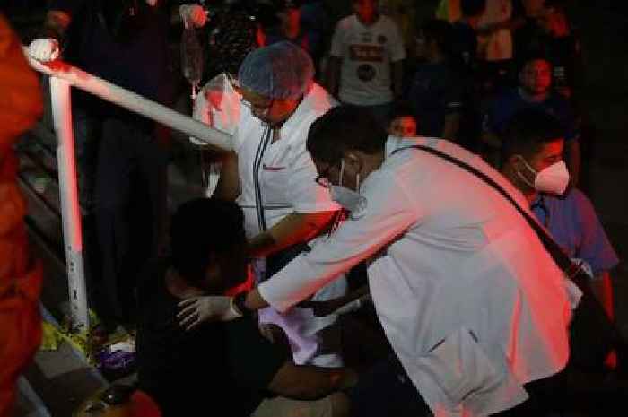 Twelve dead and 500 injured after fans storm football stadium causing horror stampede