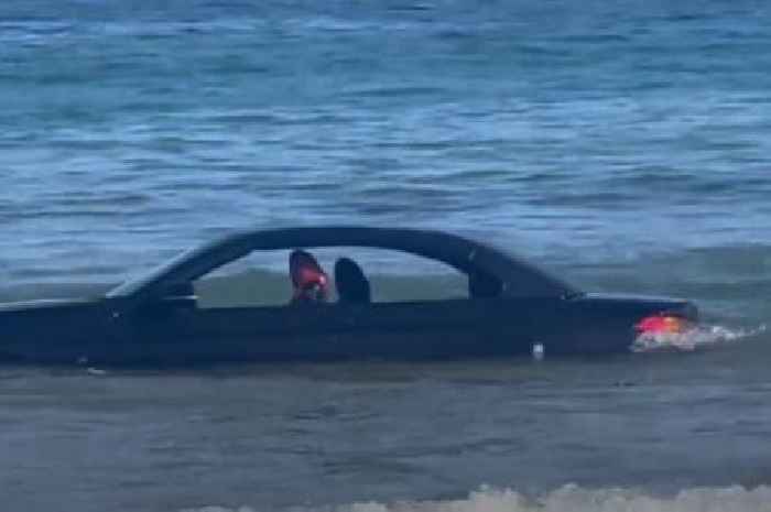 BMW convertible drifts out to sea after owner parked motor on beach