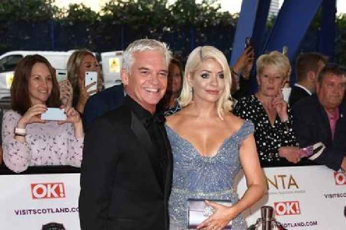Holly Willoughby pictured kissing Phillip Schofield's toyboy lover on cheek