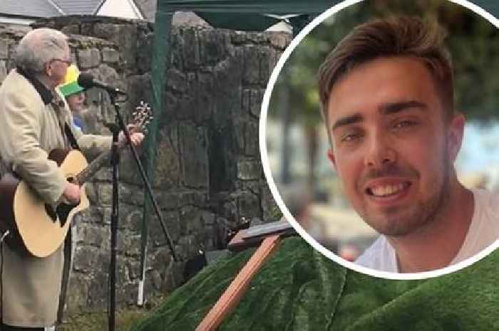 Dafydd Iwan sings Yma O Hyd next to coffin of 19-year-old football fan killed in suspected hit and run