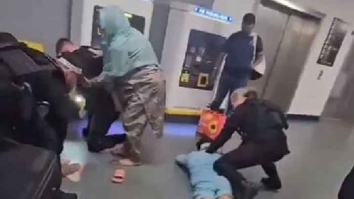 Police officer kicks and stamps on man's head at airport