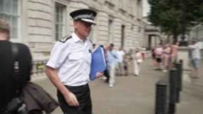Moment Met Police chief appears to push past journalist's microphone