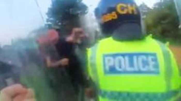 Moment police officer punched during Southport riot