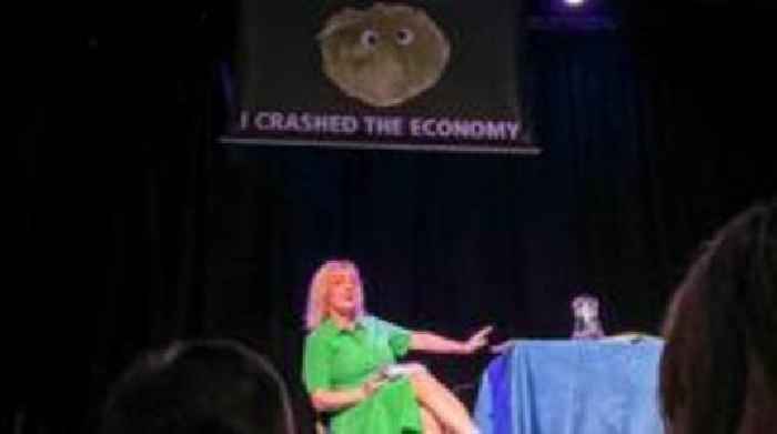 Liz Truss leaves stage as lettuce banner unfurls