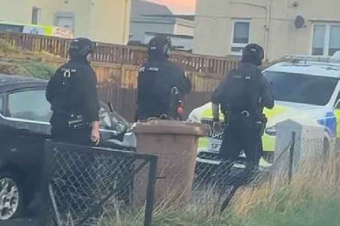 Armed police storm Scots street after 'machete wielding man kicks down door'