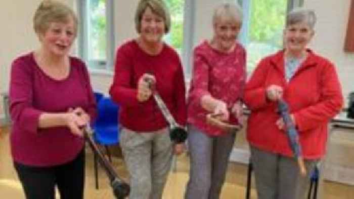 Tai Chi students learn walking stick self-defence