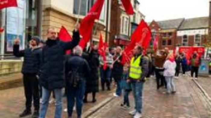 Striking food factory workers march through town