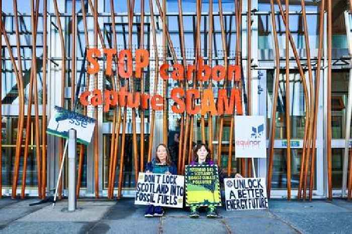 Extinction Rebellion activists clamp themselves to Scottish Parliament building