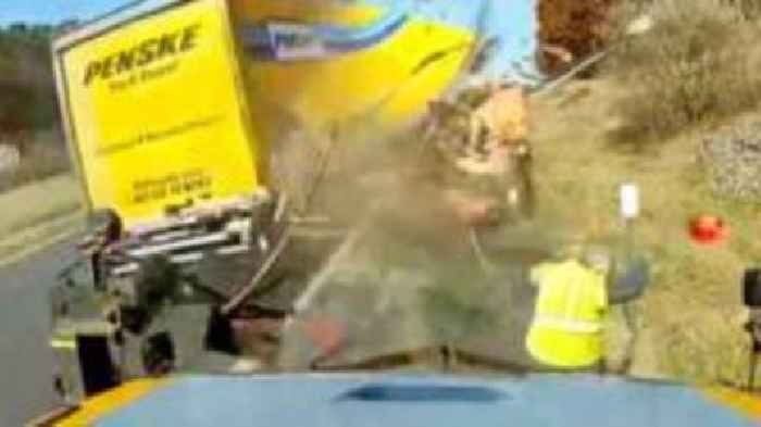 Watch: Moment road worker dodges high-speed truck crash