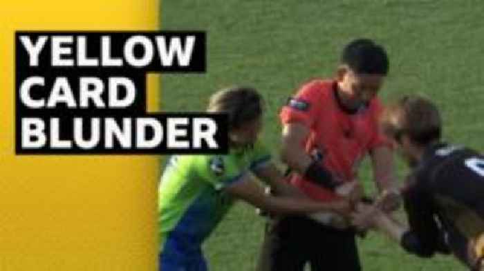 Referee needs help from players when yellow card gets stuck