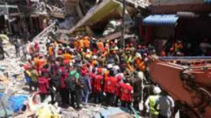 Tanzanian rescuers send water through holes to building collapse trapped