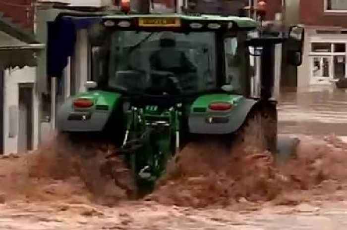 Tractor driver arrested after wave of flood water 'smashes shop windows'