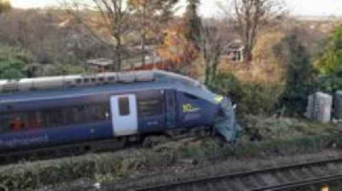 Train derails 'inches from family's garden'