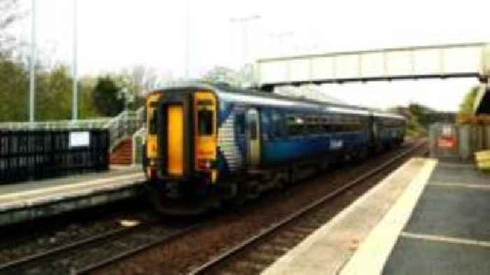 Lorry crashes off motorway onto railway line